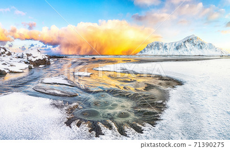 Outstanding  winter scenery on Skagsanden beach with illuminated clouds during sunrise. 71390275