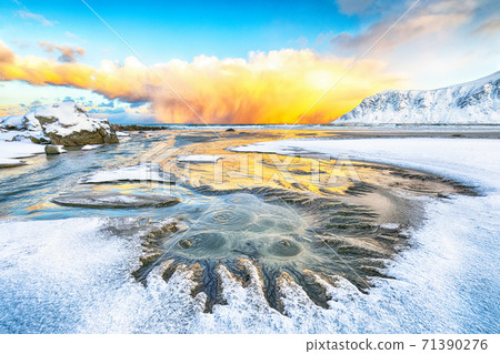 Fabulous winter scenery on Skagsanden beach with illuminated clouds during sunrise. 71390276