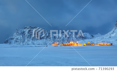 Fantastic evening illumination of traditional Norwagian houses in Utakleiv village 71390293