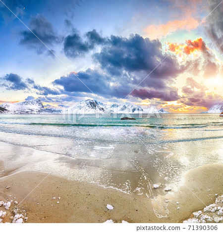 Fabulous winter scenery with Haukland beach during sunset and snowy mountain peaks near Leknes. Fabulous winter scenery with Haukland beach during sunset and snowy mountain peaks near Leknes. 71390306