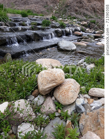 Little cute waterfall in a clear valley 71390308