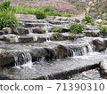 Little cute waterfall in a clear valley 71390310