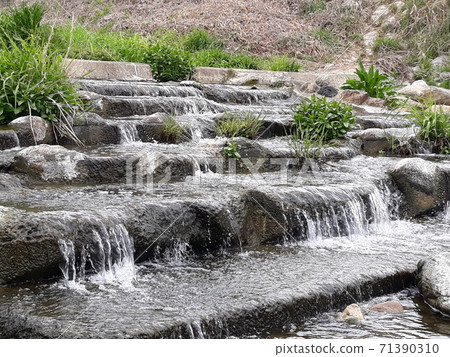 Little cute waterfall in a clear valley 71390310