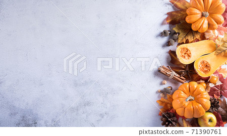 Thanksgiving background decoration from dry leaves and pumpkin on gray stone background. Flat lay, top view with copy space. Thanksgiving background decoration from dry leaves and pumpkin on gray stone background. Flat lay, top view with copy space. 71390761
