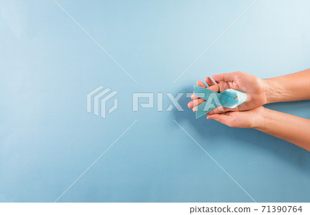 World diabetes day awareness concept. Hand holding blue ribbon, symbolic bow color raising awareness in diabetes day on pastel background,  14 November. 71390764