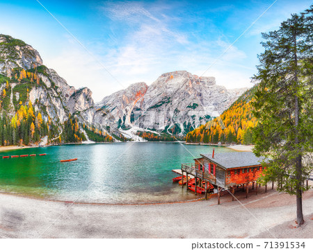 Fantastic scenery of famous alpine lake Braies at autumn. Fantastic scenery of famous alpine lake Braies at autumn. 71391534
