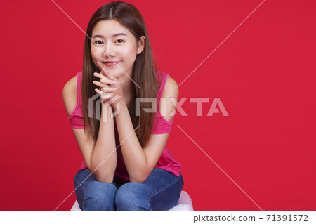 Friendly woman long hair wear pink t-shirt enjoying in studio. 71391572