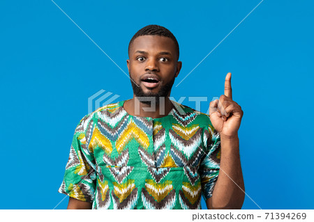 Shocked black man having idea, pointing finger up 71394269