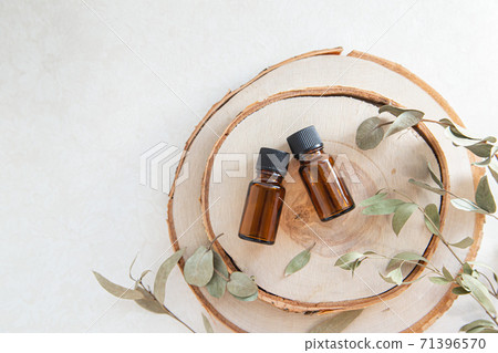 Two wood and two aroma oil bottles. Image of nature, organic and beauty. Two wood and two aroma oil bottles. Image of nature, organic and beauty. 71396570
