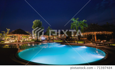 Swimming pool at resort night lighting 71397484