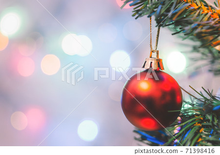 Christmas decoration. Red balls hanging on pine branches christmas tree garland and ornaments over abstract bokeh background with copy space Christmas decoration. Red balls hanging on pine branches christmas tree garland and ornaments over abstract bokeh background with copy space 71398416