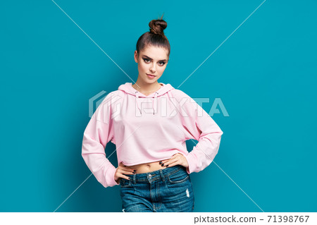 Portrait of beautiful confident young woman in casual posing on blue background 71398767