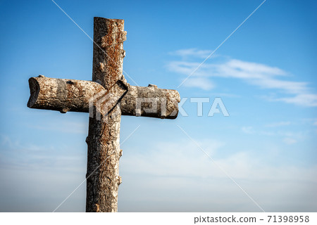 Ancient Stone Christian cross on blue sky and clouds - Lessinia Plateau Italy 71398958
