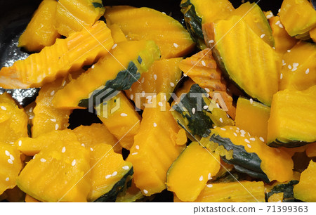 Homemade freshness organic sweet baked sliced Pumpkins topping with sesame and herbs, advertisement food backgrounds Homemade freshness organic sweet baked sliced Pumpkins topping with sesame and herbs, advertisement food backgrounds 71399363