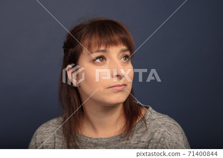 woman in her thirties looking up studio portrait 71400844