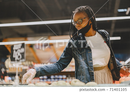 Black girl in a mask buy a food 71401105