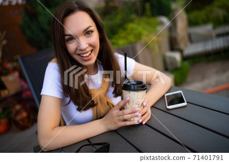 charming young business woman having coffee break sitting on cafe terrace 71401791