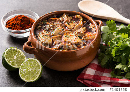 Traditional mondongo or el menudo soup on black stone Traditional mondongo or el menudo soup on black stone 71401868