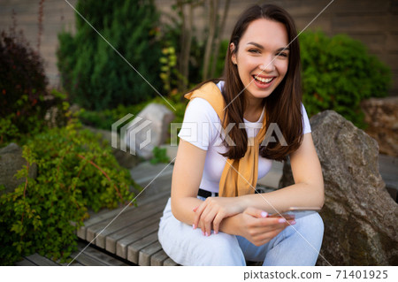 woman freelancer resting in a summer green park 71401925