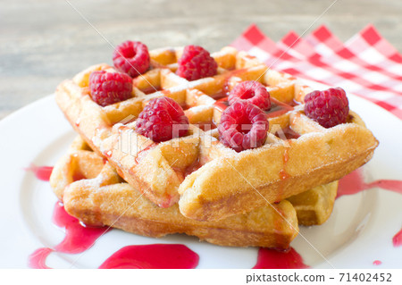 Waffles with raspberries and strawberry syrup	 71402452