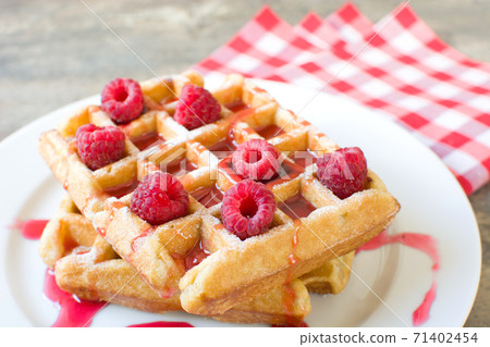 Waffles with raspberries and strawberry syrup	 71402454