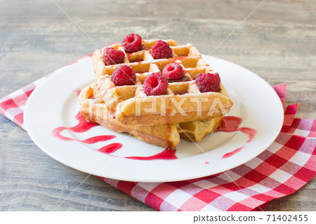 Waffles with raspberries and strawberry syrup	 71402455