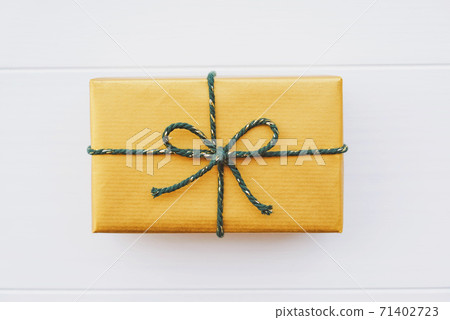 Wrapped Christmas gift box with green ribbon on white background. Wrapped Christmas gift box with green ribbon on white background. 71402723