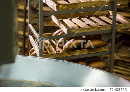 Hot bread from the conveyor. Hot bread from the conveyor. 71402733