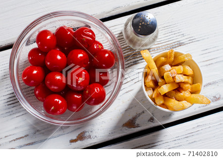 Tomatoes, fries and pepperbox. 71402810