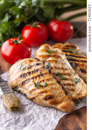 Grilled chicken breast on butcher board close up 71403025
