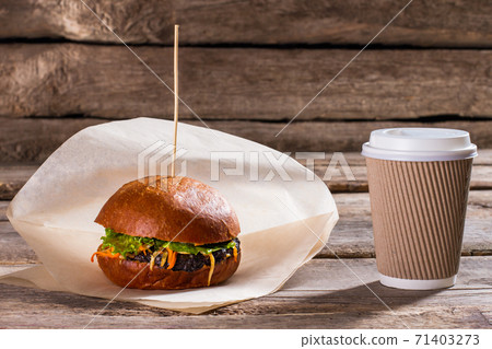 Hamburger and paper coffee cup. Hamburger and paper coffee cup. 71403273