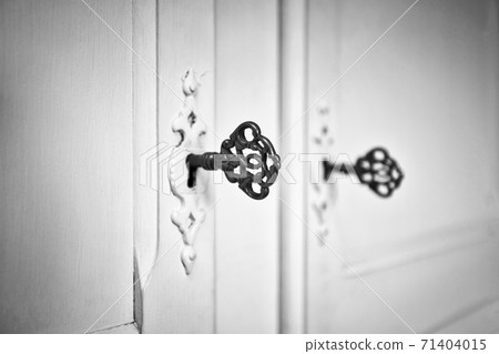 Old vintage doors with antique skeleton keys in lock, retro background texture black and white Old vintage doors with antique skeleton keys in lock, retro background texture black and white 71404015