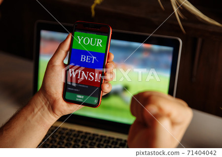 Cropped shot close up of male fist clenched with triumph in front of laptop screen. Bet wins Cropped shot close up of male fist clenched with triumph in front of laptop screen. Bet wins 71404042