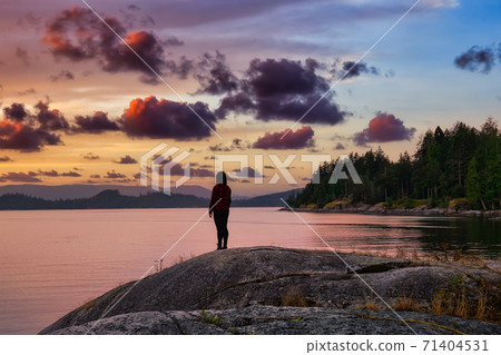 Girl Watching a Peaceful Sunrise on the Ocean Coast Girl Watching a Peaceful Sunrise on the Ocean Coast 71404531