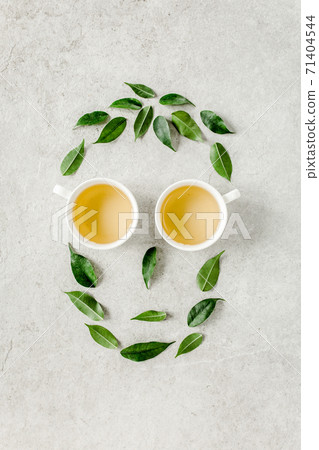Cup of fresh green tea with tea leaves. Flat lay, top view. Tea concept Cup of fresh green tea with tea leaves. Flat lay, top view. Tea concept 71404544