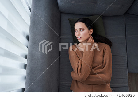Sad woman laying at the sofa 71406929