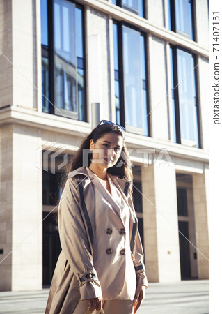 young pretty brunette woman in fashion suit at business building posing cheerful, lifestyle people concept young pretty brunette woman in fashion suit at business building posing cheerful, lifestyle people concept 71407131