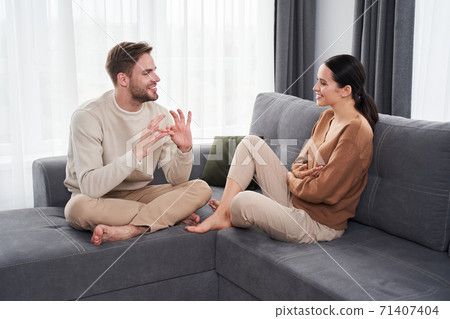 Husband and wife talking with help of sign language 71407404