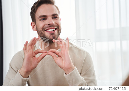 Deaf man and his wife sitting on couch Deaf man and his wife sitting on couch 71407413