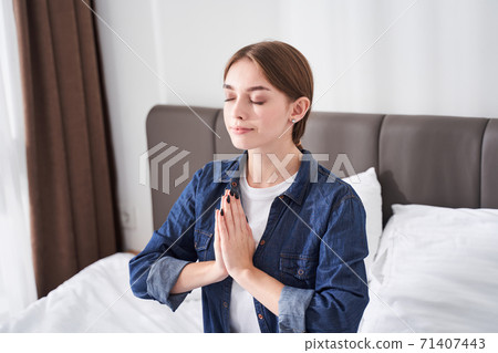 Woman sitting in meditative pose Woman sitting in meditative pose 71407443