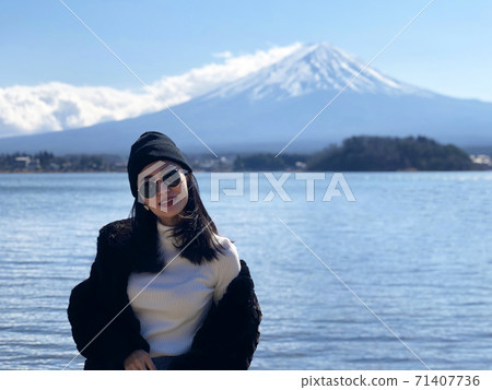 woman tourists are traveling feel happy with Mt Fuji in the morning on the lake kawaguchiko, Japan woman tourists are traveling feel happy with Mt Fuji in the morning on the lake kawaguchiko, Japan 71407736