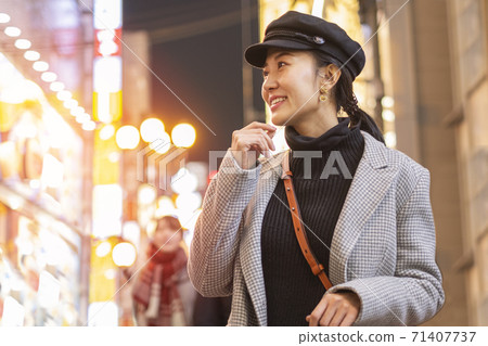 smiling woman tourists traveling in walking at street shopping center Shibuya in Tokyo, Japan. 71407737