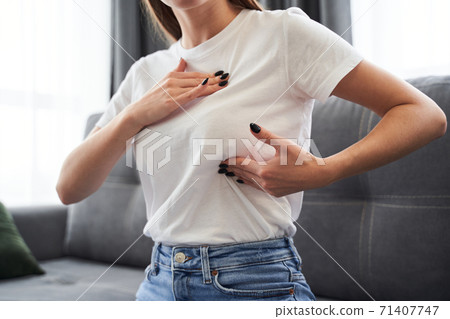 Woman checking her breasts shape 71407747