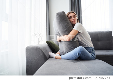 Woman suffering while looking away Woman suffering while looking away 71407764