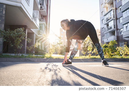 Woman stretching in the urban street Woman stretching in the urban street 71408307