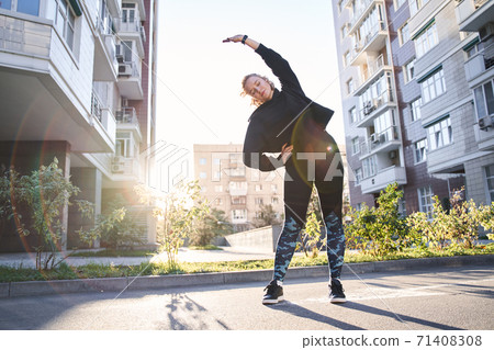 Woman warming up before jogging 71408308