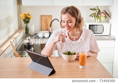 Woman watching funny movie Woman watching funny movie 71408360