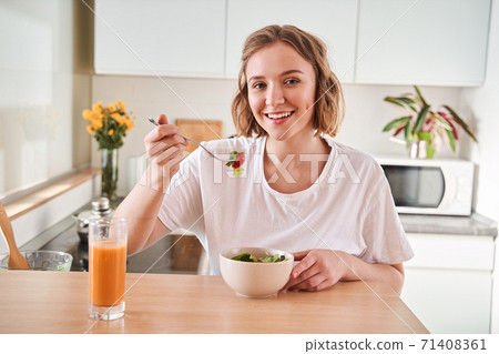 Woman eating fresh salad Woman eating fresh salad 71408361