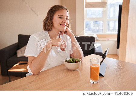 Woman holding fork at the plate Woman holding fork at the plate 71408369