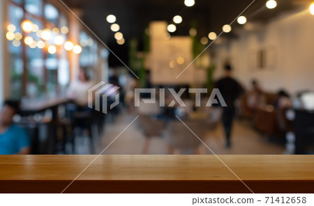 wooden table with blurred cafe restaurant wooden table with blurred cafe restaurant 71412658